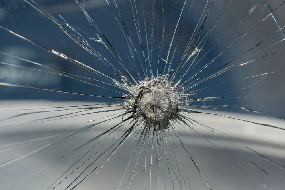 Fresh rock chip damage on a windshield before repair
